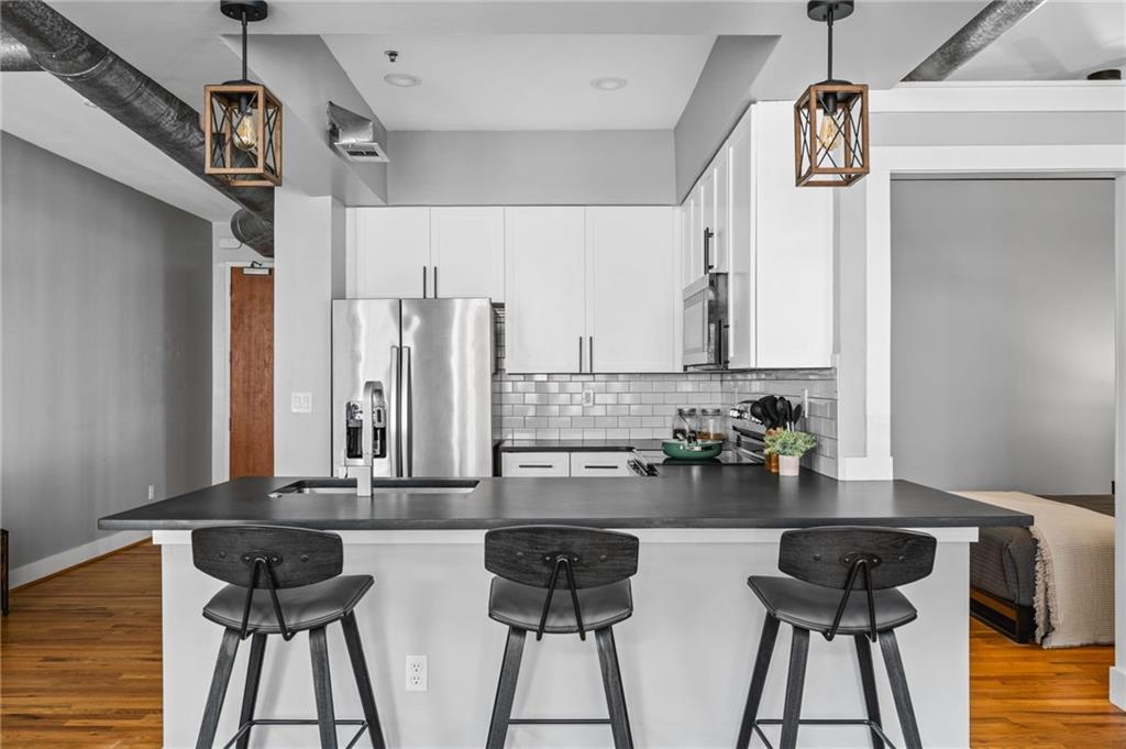 1029 Piedmont Avenue Northeast, Unit 303 Atlanta, GA 30309 - Photo 8 of 44 a table with a potted plant and a stove