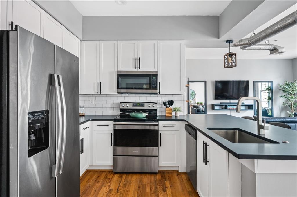 1029 Piedmont Avenue Northeast, Unit 303 Atlanta, GA 30309 - Photo 10 of 44 a kitchen with stainless steel appliances a sink stove and refrigerator