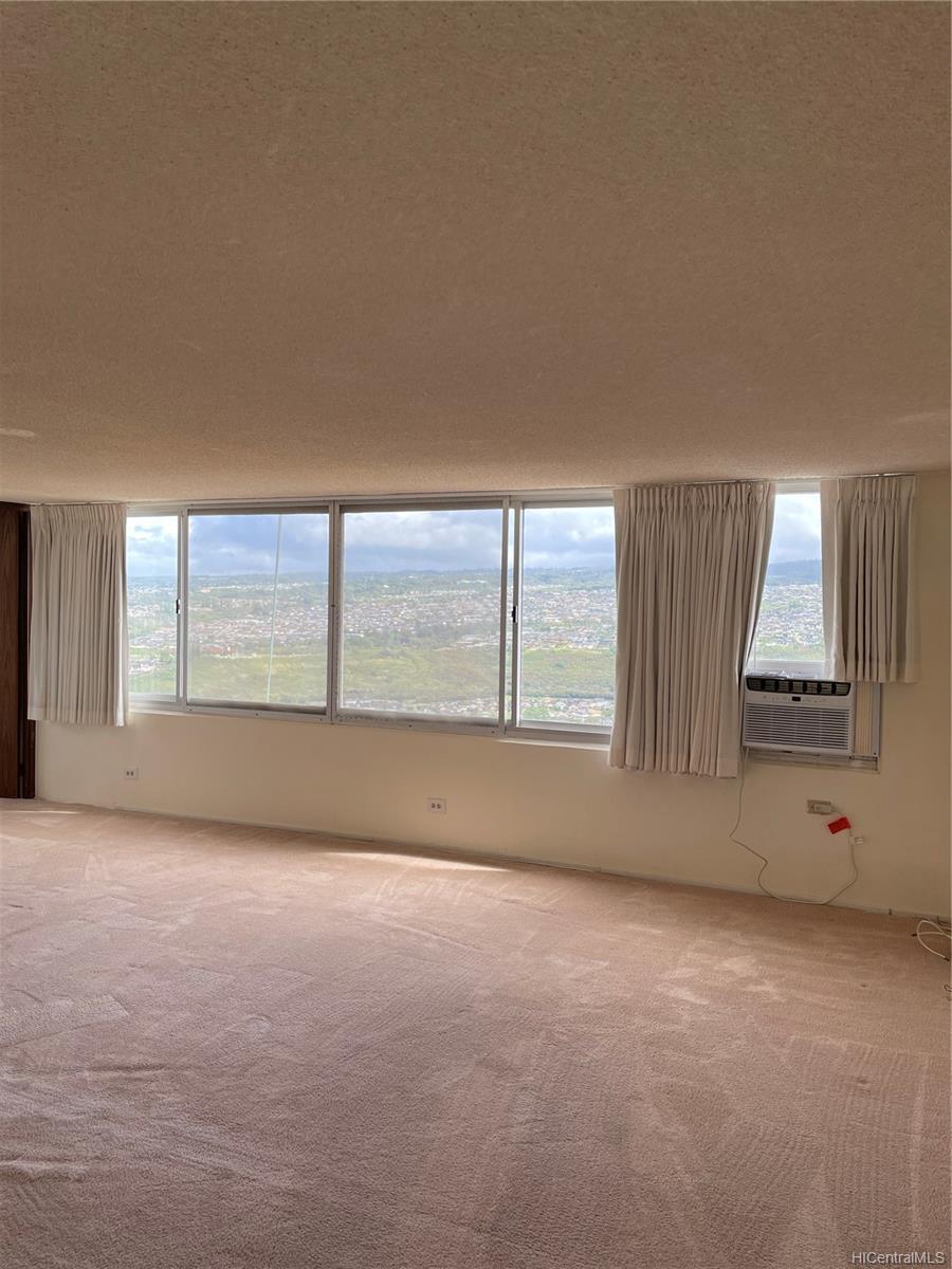 an empty room with large windows