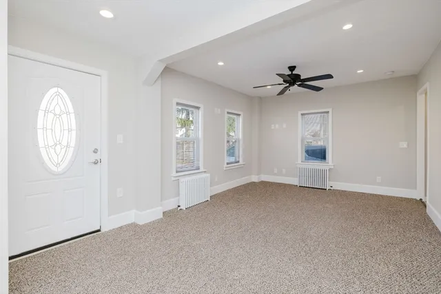 an empty room with windows and closet