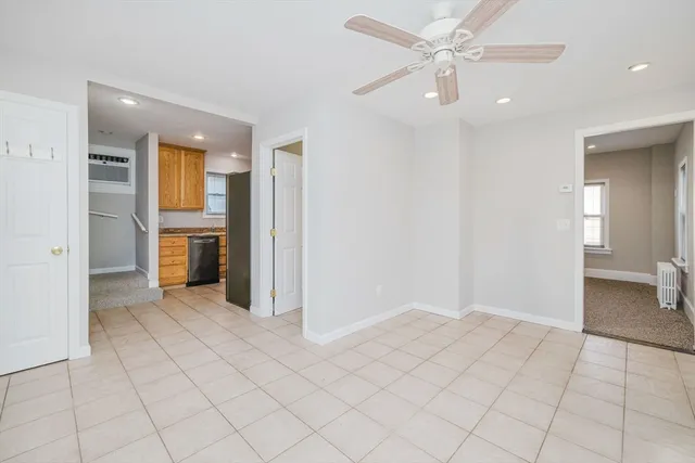 an empty room with closet and fan