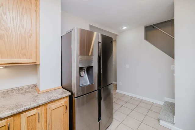a kitchen with stainless steel appliances granite countertop a refrigerator and a sink