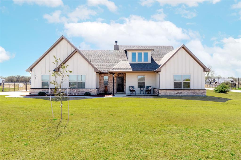 a view of a house with swimming pool and a yard