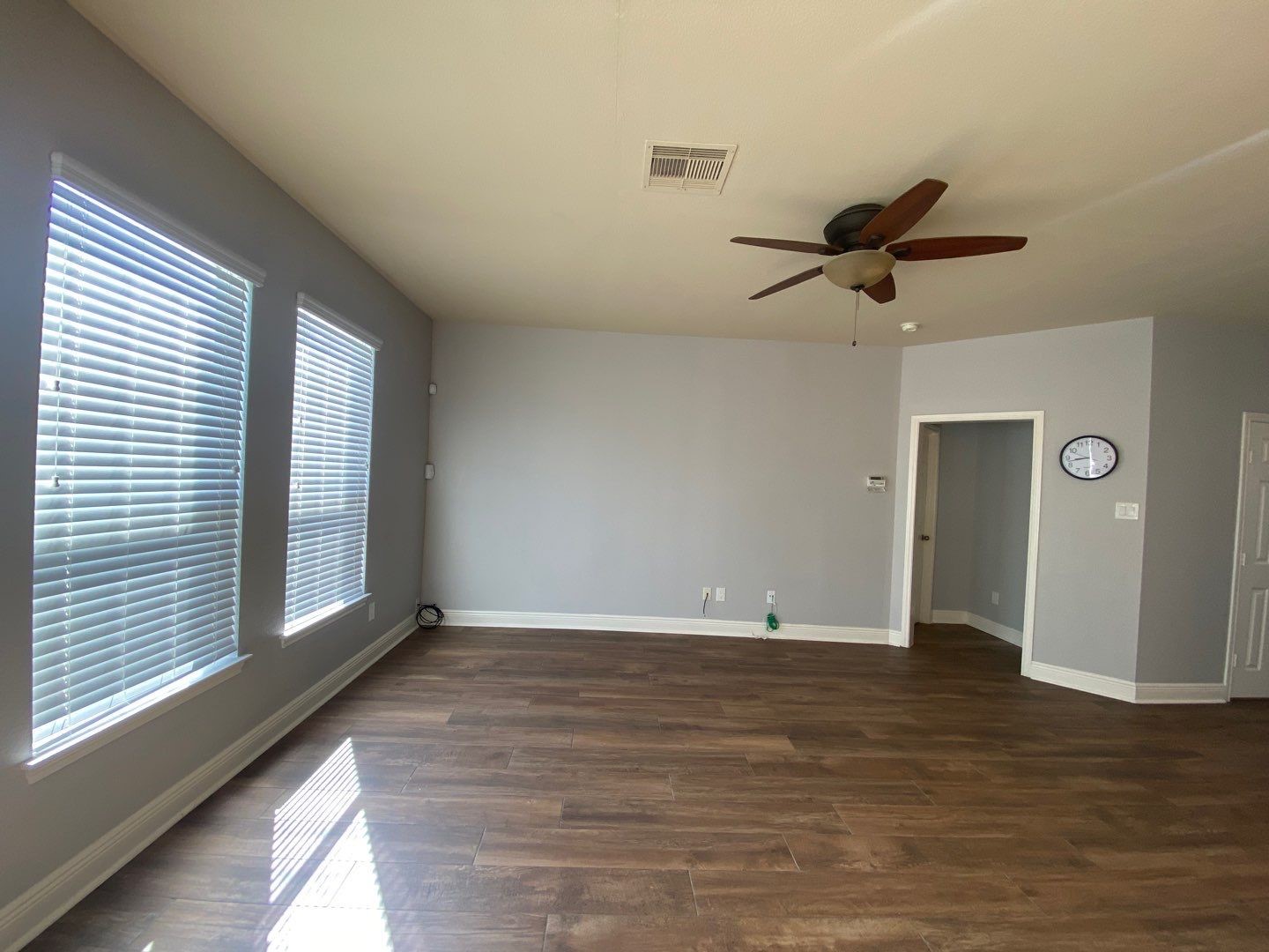 2101 Crestwind Court Pearland, TX 77584 - Photo 12 of 41 a view of an empty room with a window and wooden floor