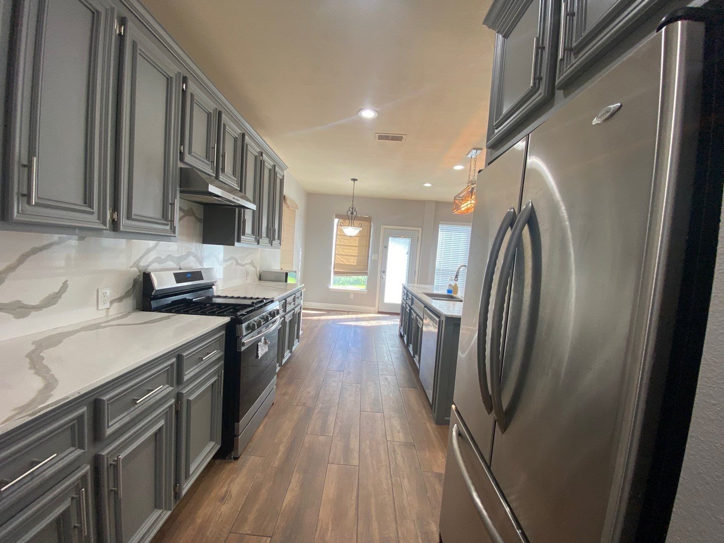 2101 Crestwind Court Pearland, TX 77584 - Photo 14 of 41 a kitchen with stainless steel appliances granite countertop a refrigerator a stove top oven a sink and dishwasher