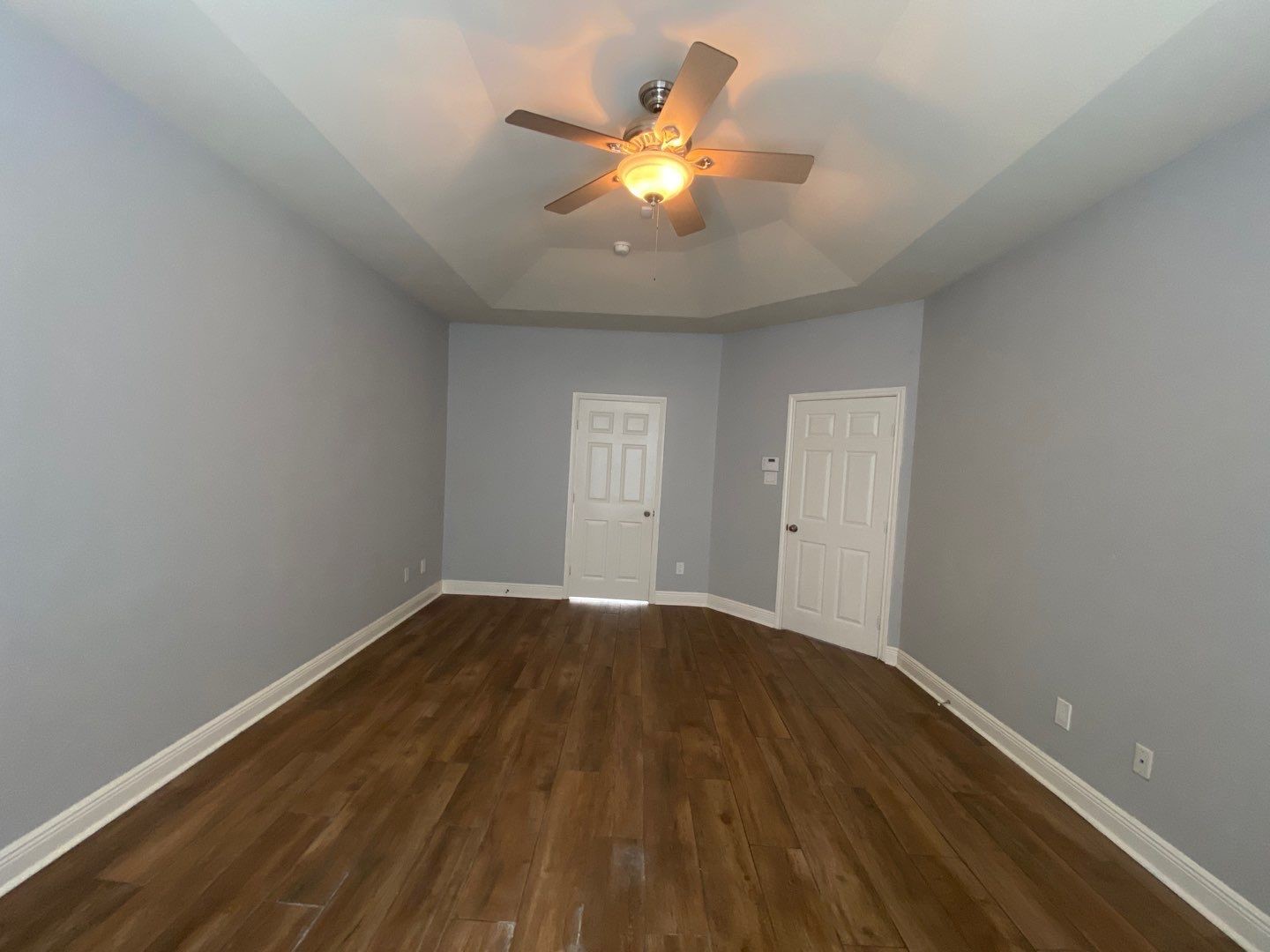 2101 Crestwind Court Pearland, TX 77584 - Photo 18 of 41 a view of an empty room with wooden floor and a ceiling fan