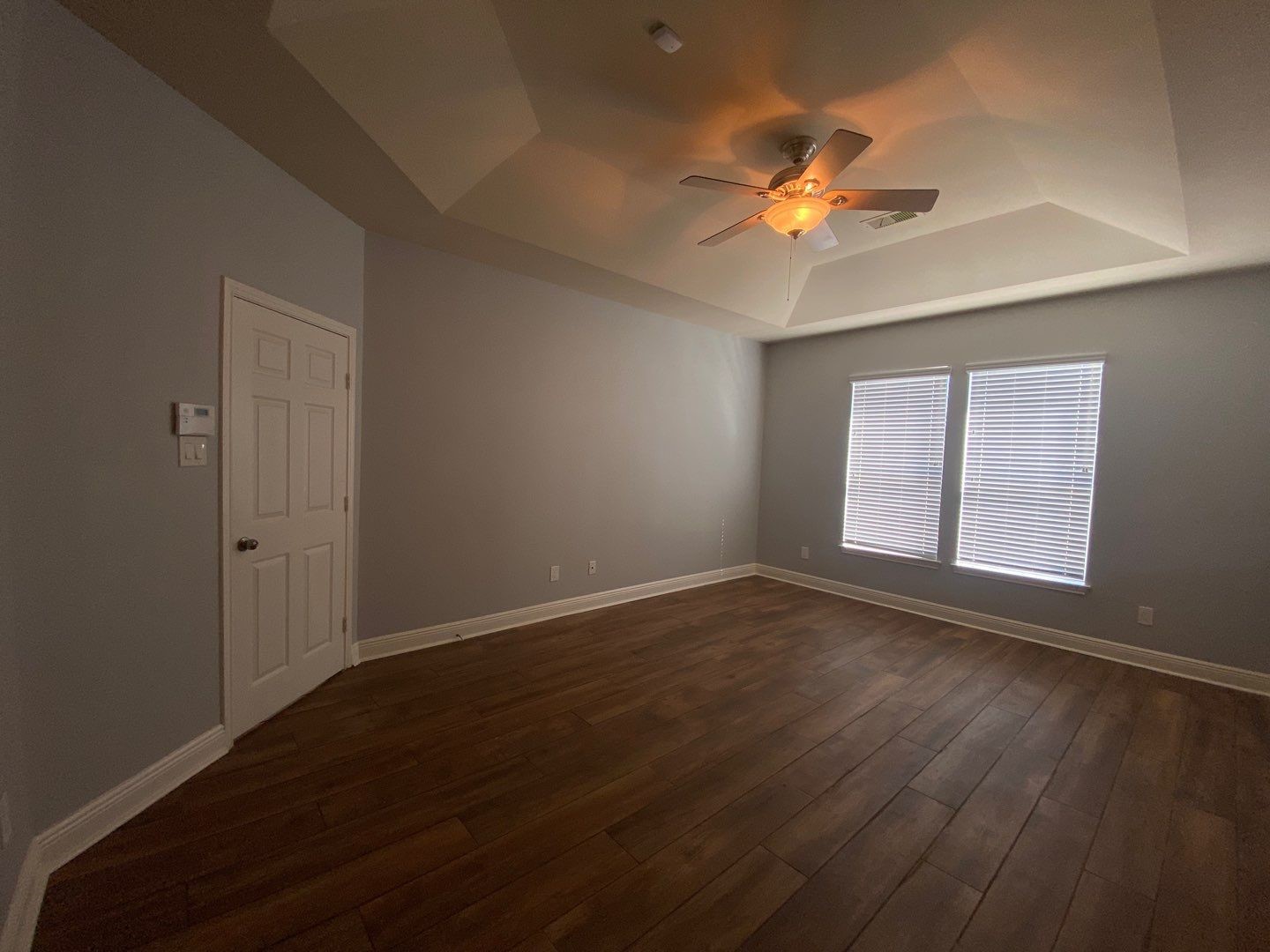 2101 Crestwind Court Pearland, TX 77584 - Photo 32 of 41 a view of an empty room with wooden floor and a window