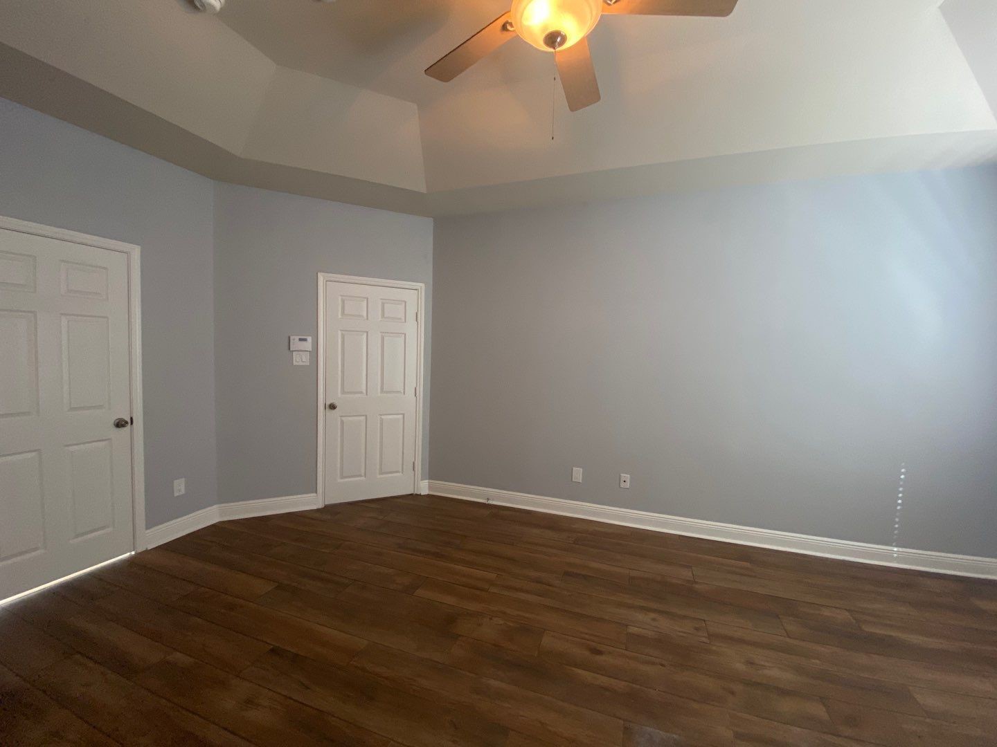 2101 Crestwind Court Pearland, TX 77584 - Photo 37 of 41 a view of an empty room with wooden floor chandelier fan