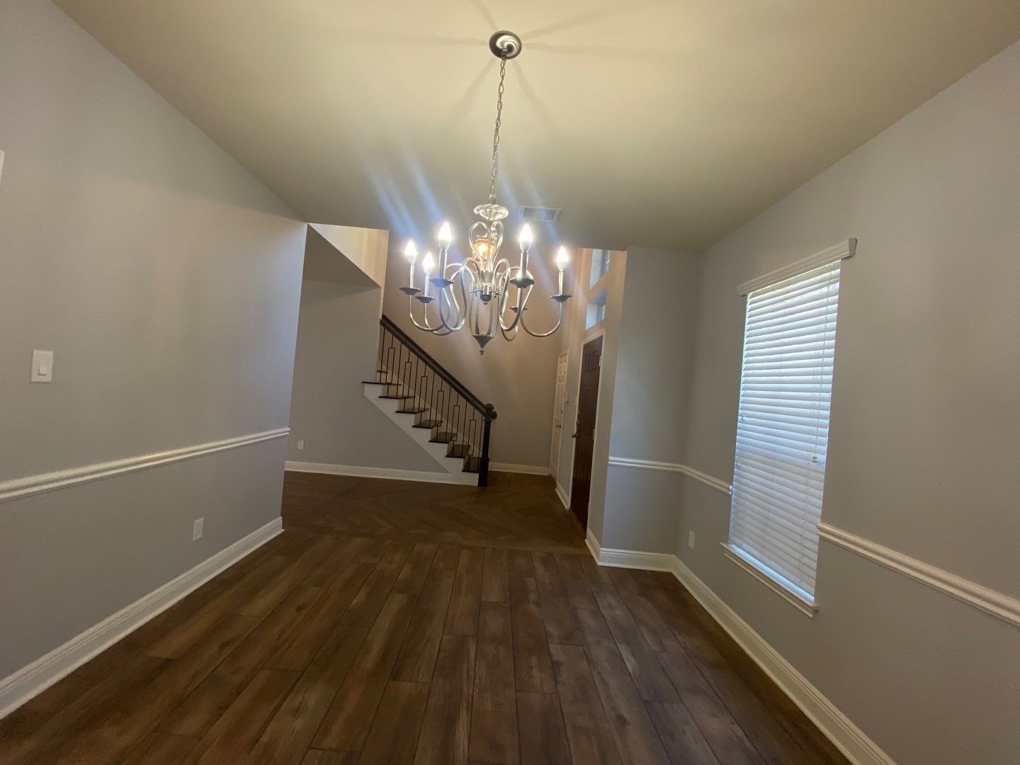 2101 Crestwind Court Pearland, TX 77584 - Photo 5 of 41 a view of a room with wooden floor and chandelier