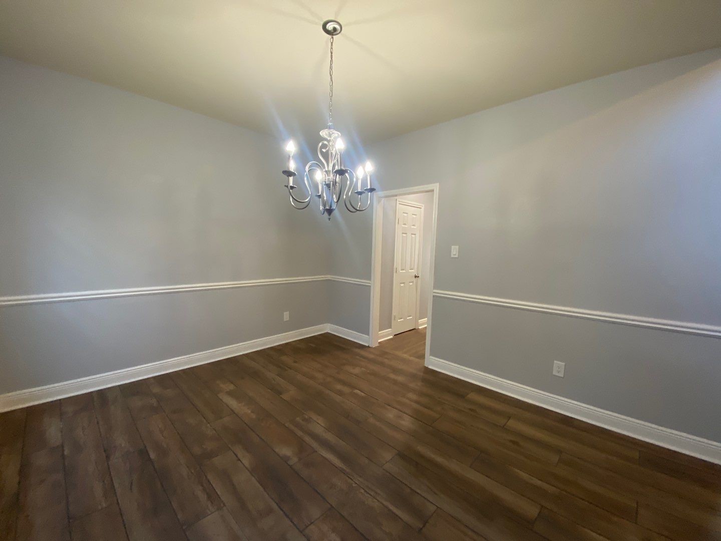 2101 Crestwind Court Pearland, TX 77584 - Photo 7 of 41 a view of a room with wooden floor and chandelier