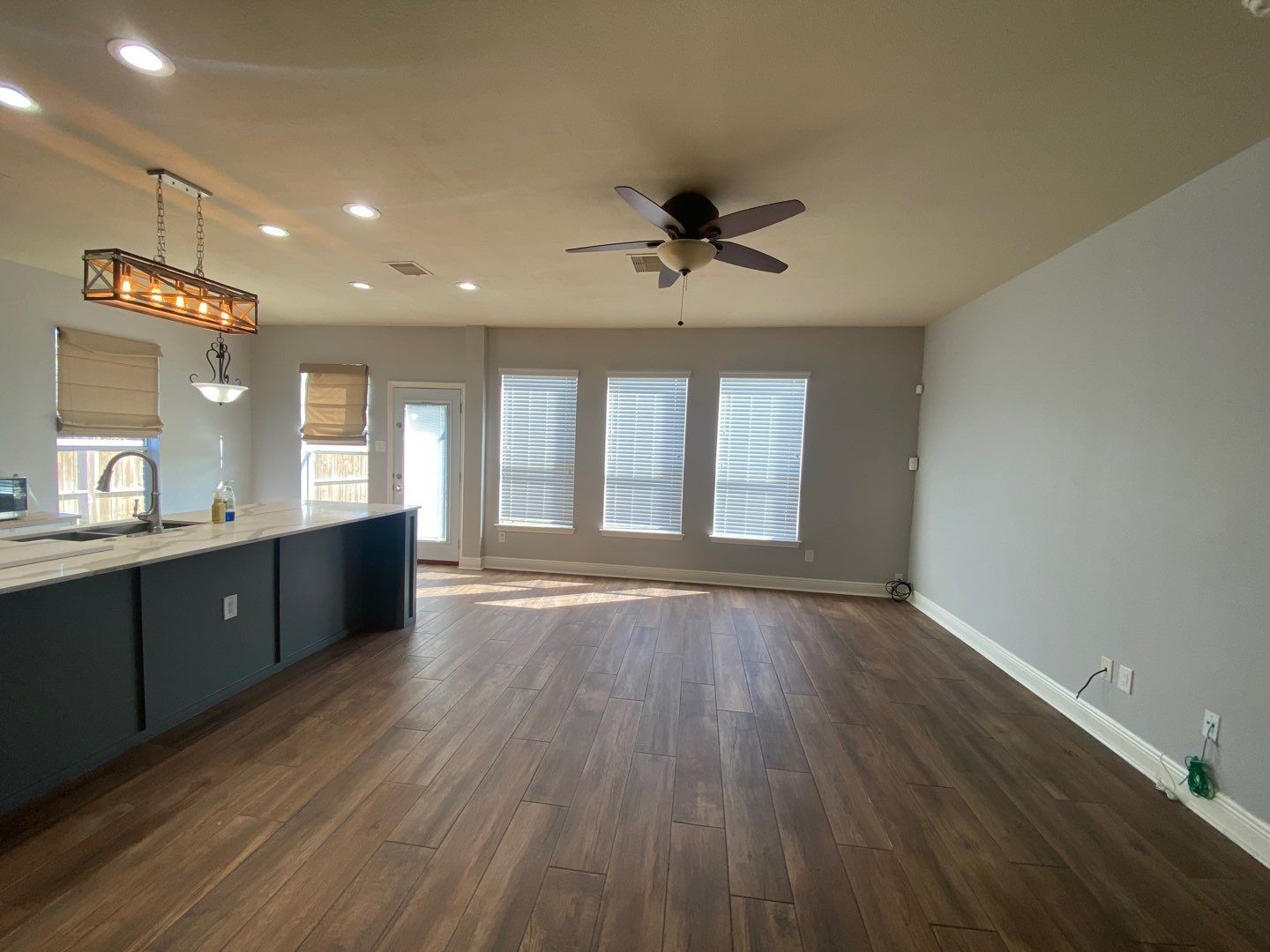 2101 Crestwind Court Pearland, TX 77584 - Photo 10 of 41 a view of an empty room with window and wooden floor
