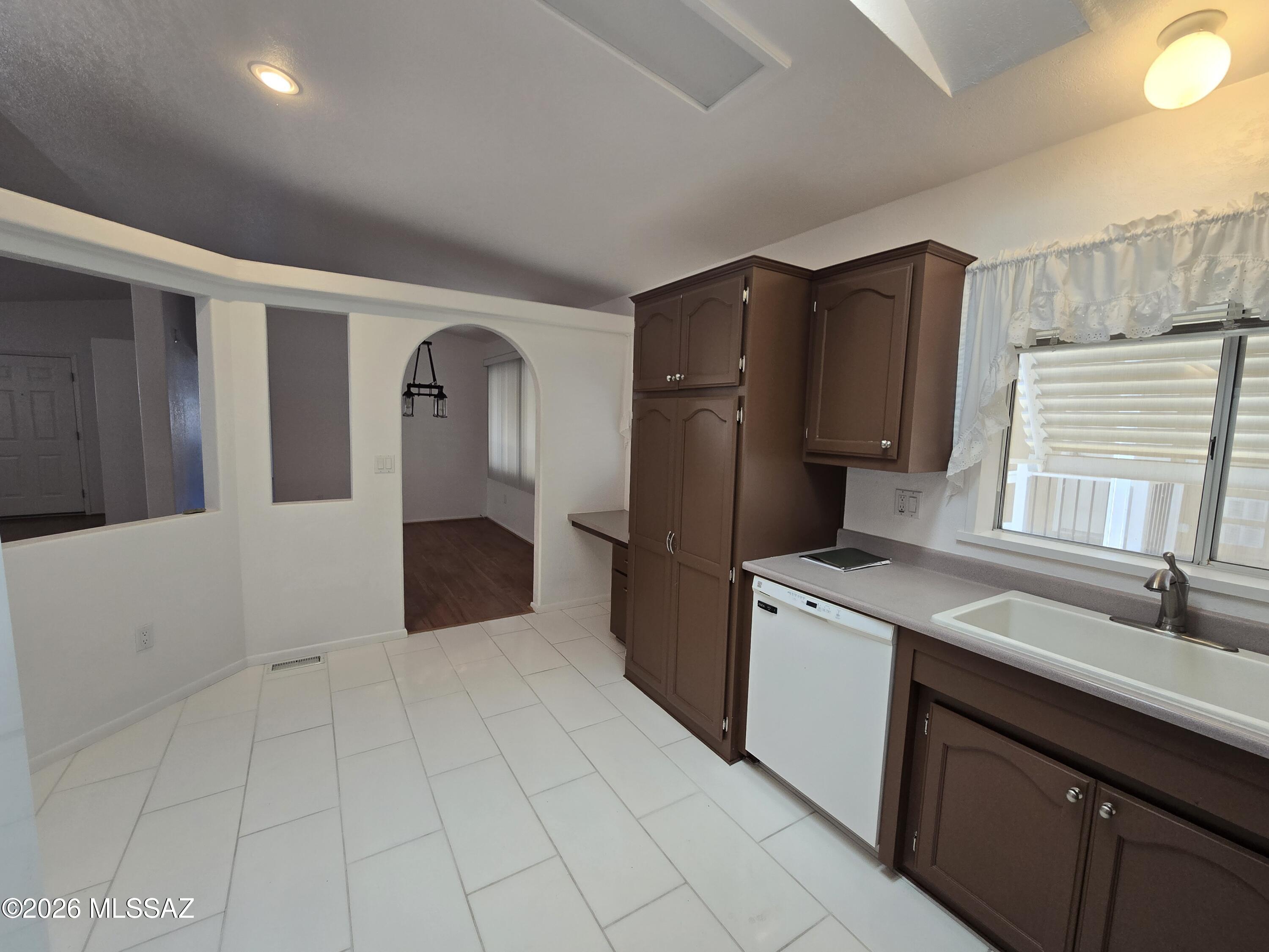 8401 South Kolb Road, Unit 61 Tucson, AZ 85756 - Photo 13 of 23 a kitchen with a sink a refrigerator and cabinets