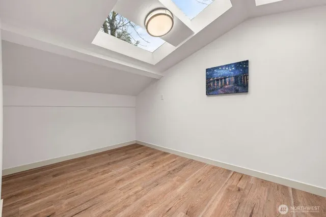 a view of a room with wooden floor and window