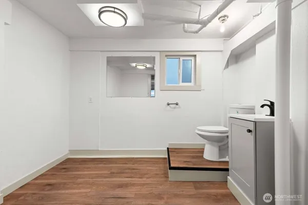 a view of a bathroom with wooden floor and a sink