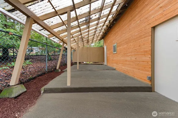 a view of a porch with furniture and a backyard