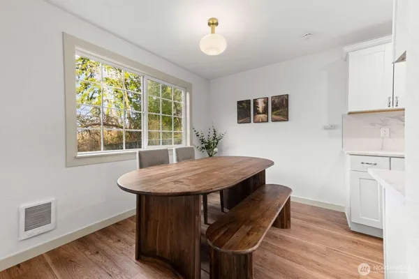 a view of a dining room with furniture window and wooden floor