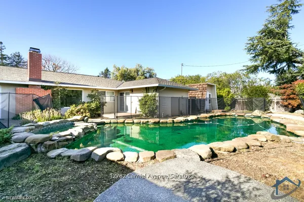 a view of a backyard with plants and patio