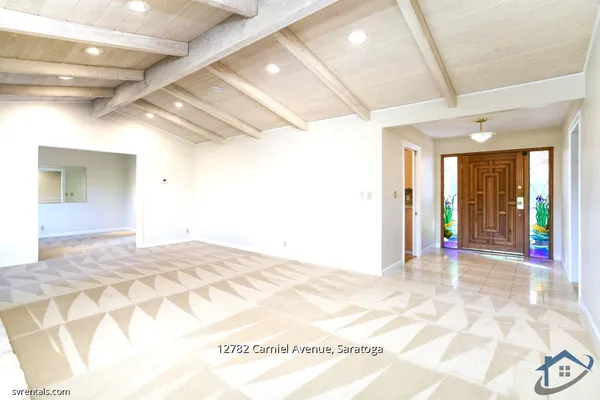 a view of a hallway with wooden floor and a chandelier
