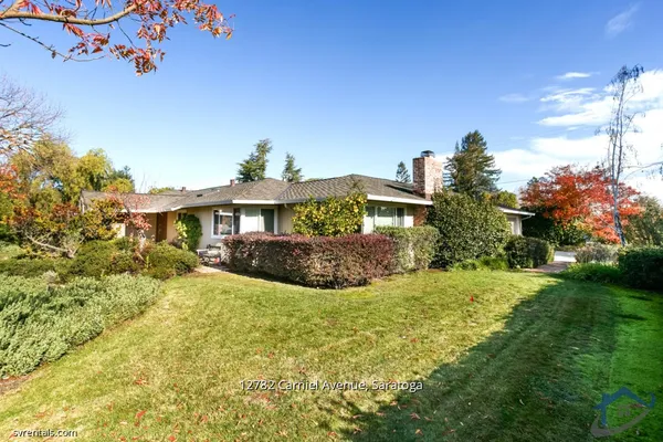 a view of a house with a big yard and potted plants
