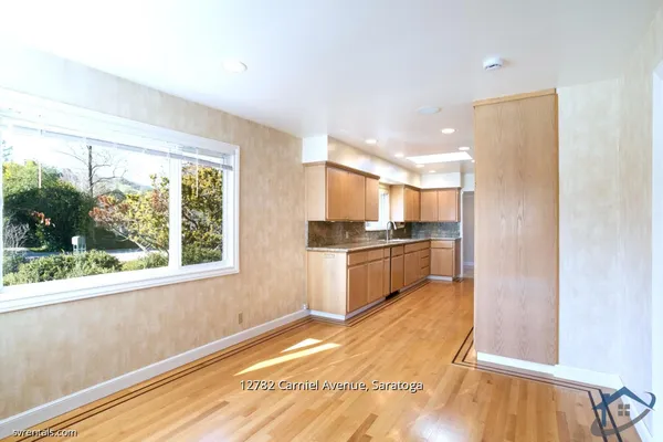 a kitchen with a refrigerator and a window