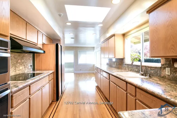 a view of a kitchen with a large window