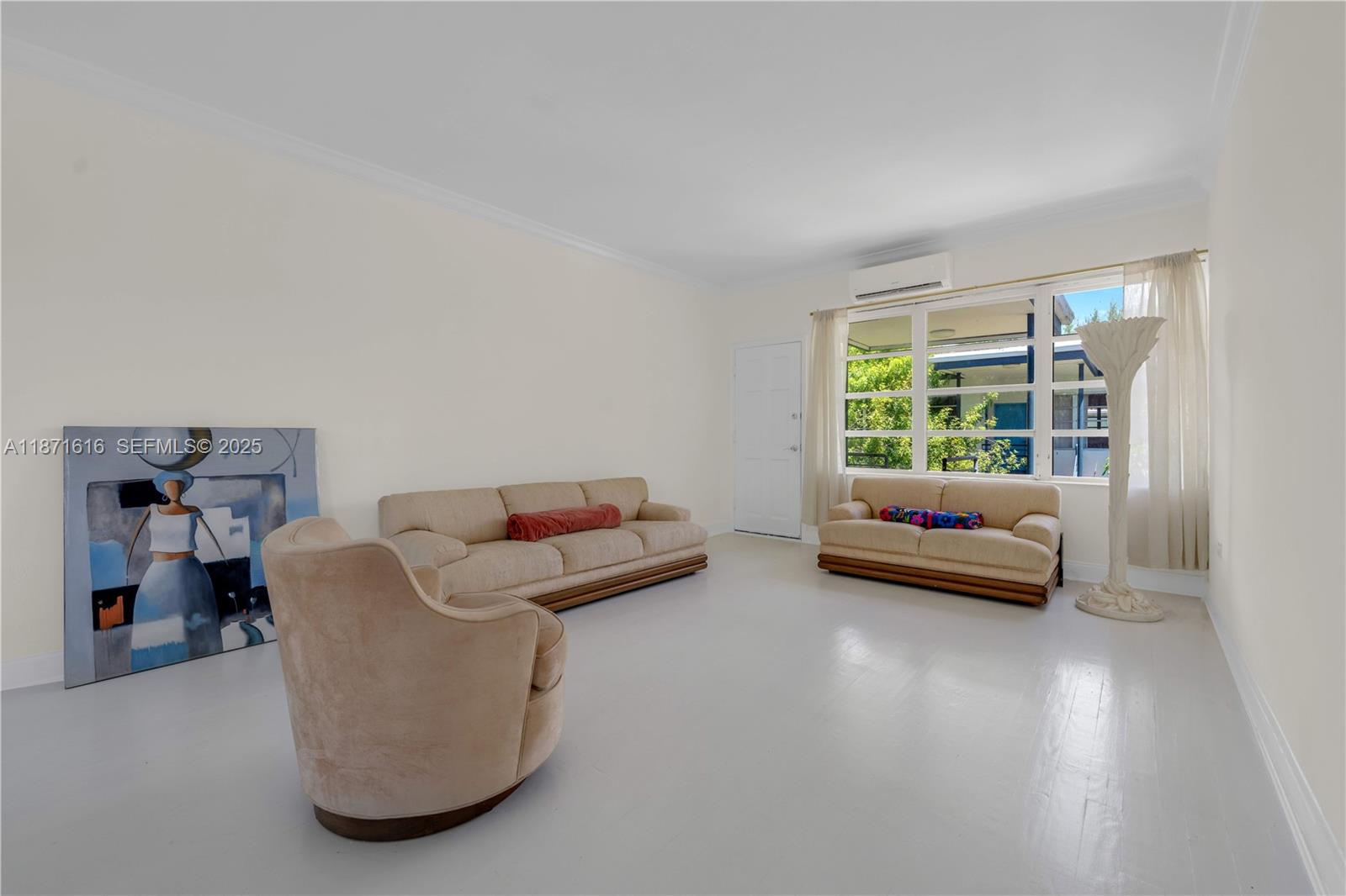 4710 Pine Tree Drive, Unit 26 Miami Beach, FL 33140 - Photo 8 of 20 a living room with furniture and a window