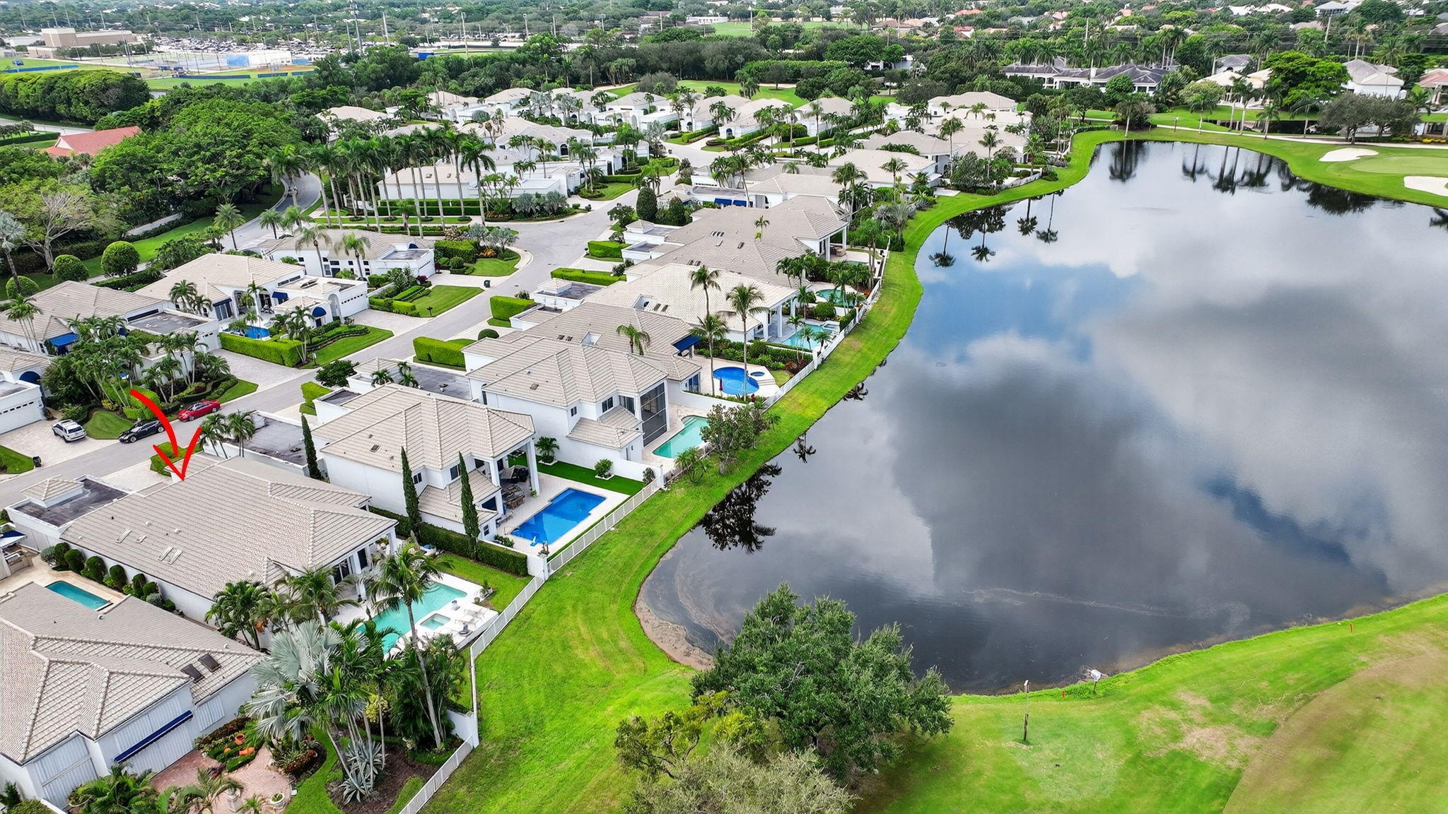 2563 Northwest 63rd Street Boca Raton, FL 33496 - Photo 63 of 65 an aerial view of a house with a yard and lake view