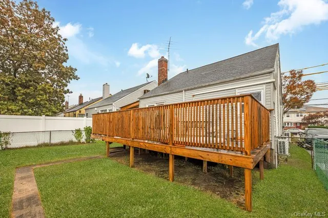 a backyard of a house with a garden and barbeque oven