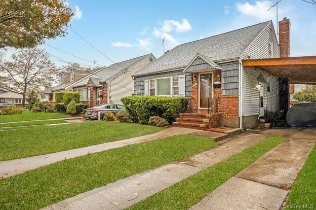 a front view of a house with a garden and plants