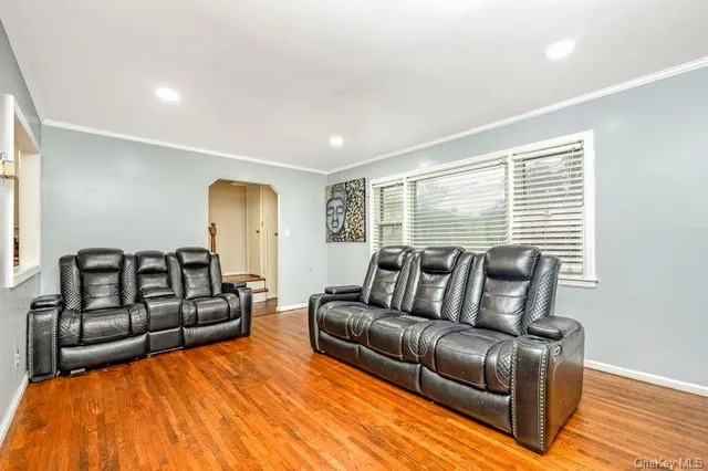 a spacious bedroom with a bed window and couch