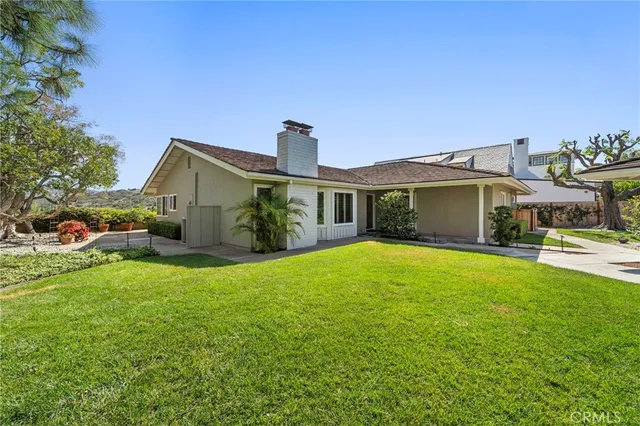 a front view of a house with a garden and yard