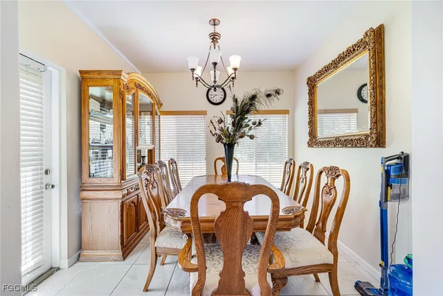 a view of a dining room with furniture wooden floor and chandelier