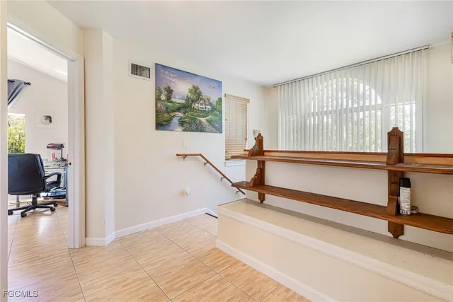 a view of a room with gym equipment and windows