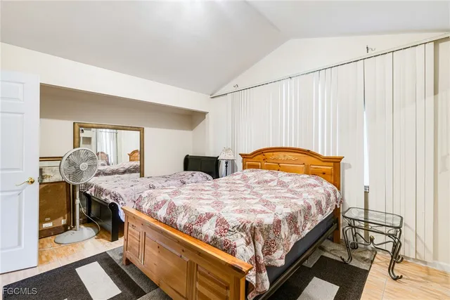 a bedroom with bed and window