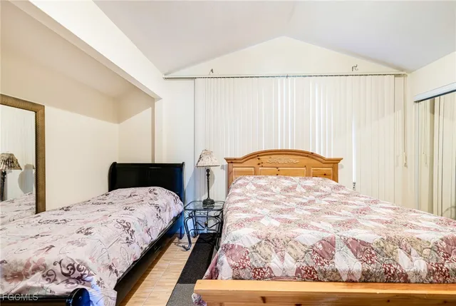 a bedroom with a bed and a mirror