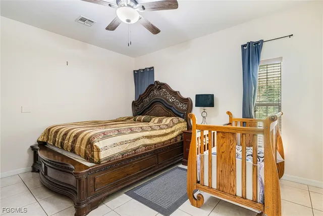 a bedroom with bed and wooden floor