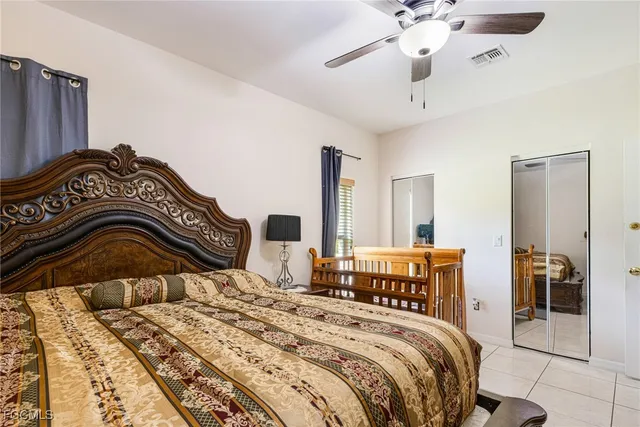 a bedroom with bed and a chandelier