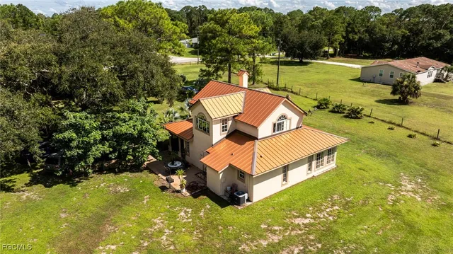 an aerial view of a house with yard swimming pool and outdoor seating