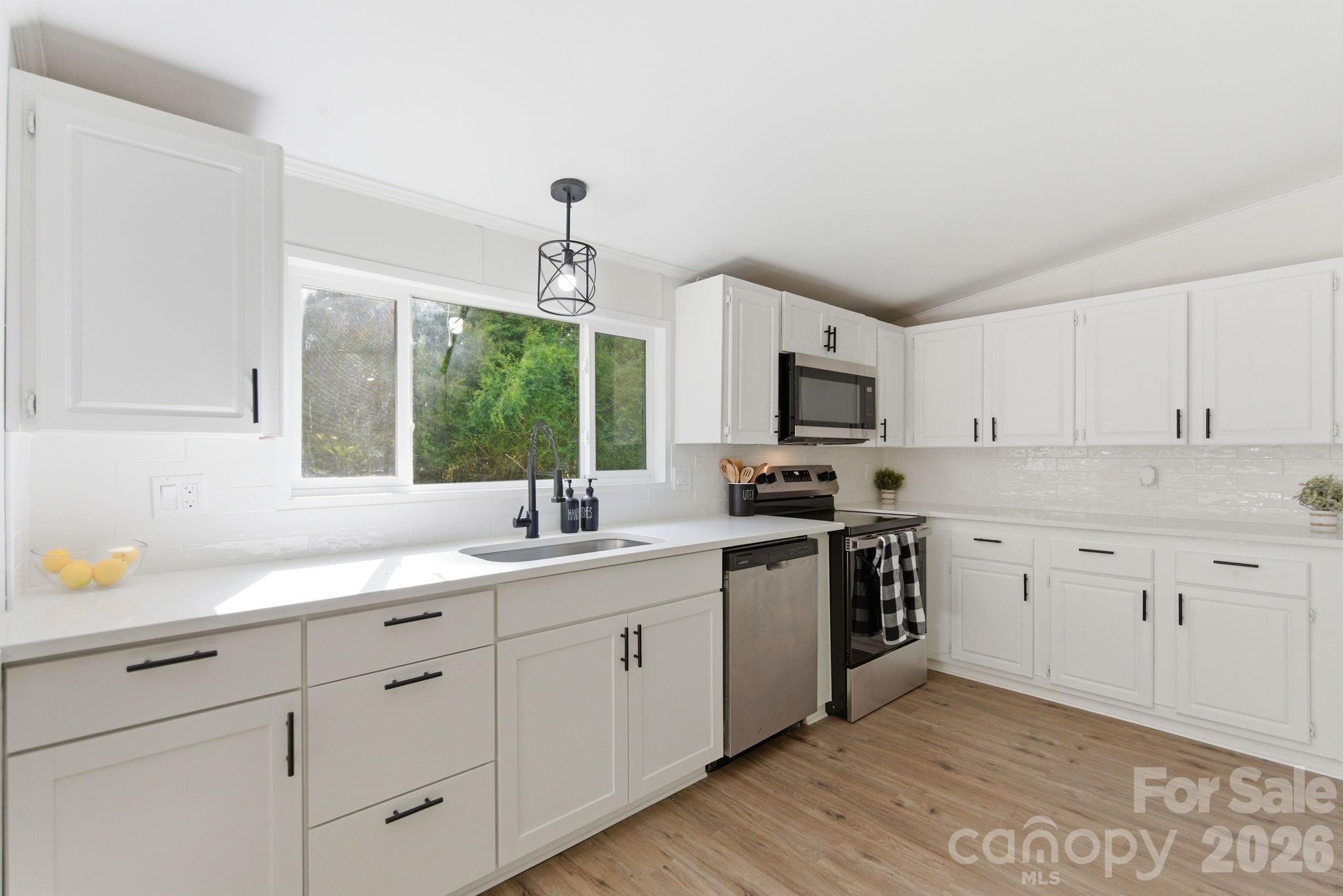 481 Harrell Road Burgaw, NC 28425 - Photo 7 of 25 a kitchen with sink cabinets and appliances