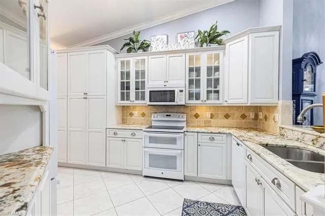 a kitchen with a stove a sink and a refrigerator