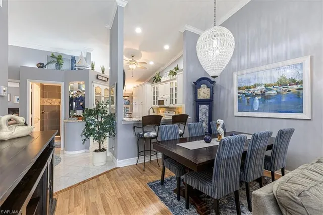 a view of a dining room with furniture wooden floor and a chandelier