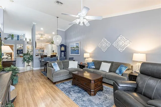 a living room with furniture a rug and a chandelier
