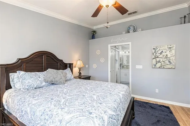 a bedroom with a bed and a ceiling fan