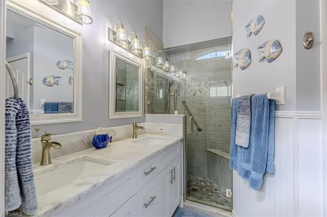 a bathroom with a granite countertop shower sink and mirror