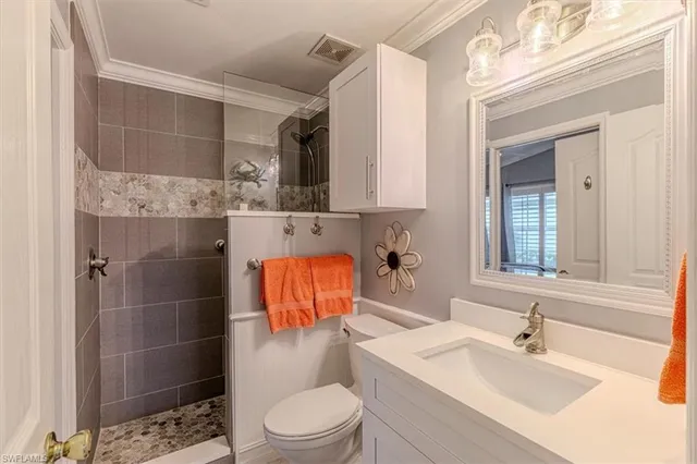 a bathroom with a sink toilet and shower