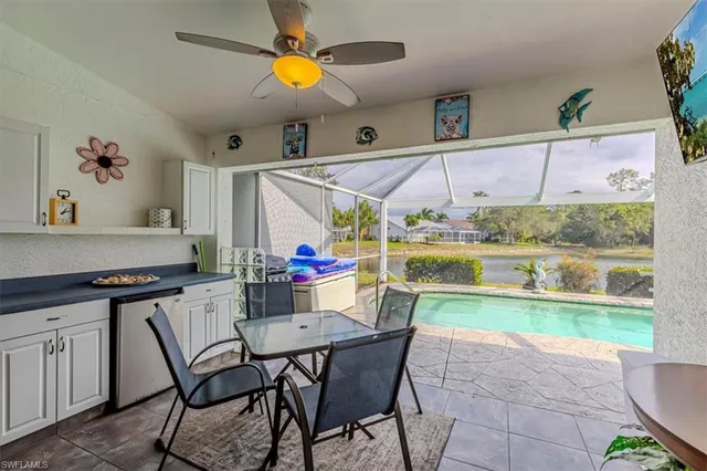 a dining room with furniture and a floor to ceiling window