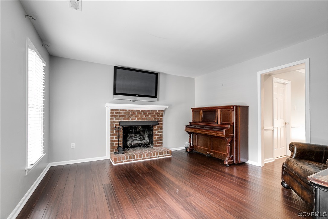 13212 Court Ridge Road Midlothian, VA 23112 - Photo 7 of 33 a living room with furniture a flat screen tv and a fireplace