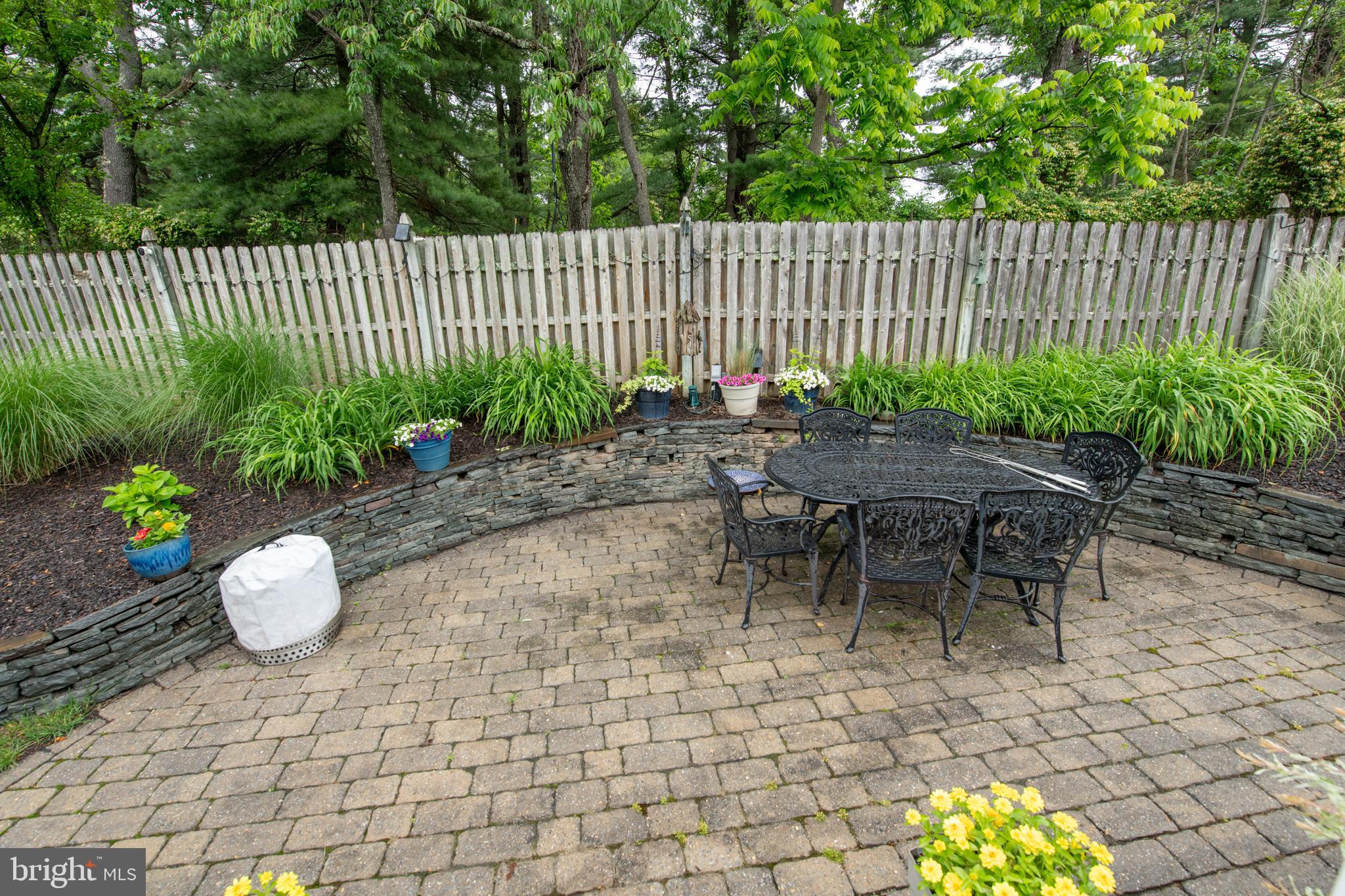 32 Eagleton Farm Road Newtown, PA 18940 - Photo 34 of 39 a table and chair sitting in backyard with wooden fence