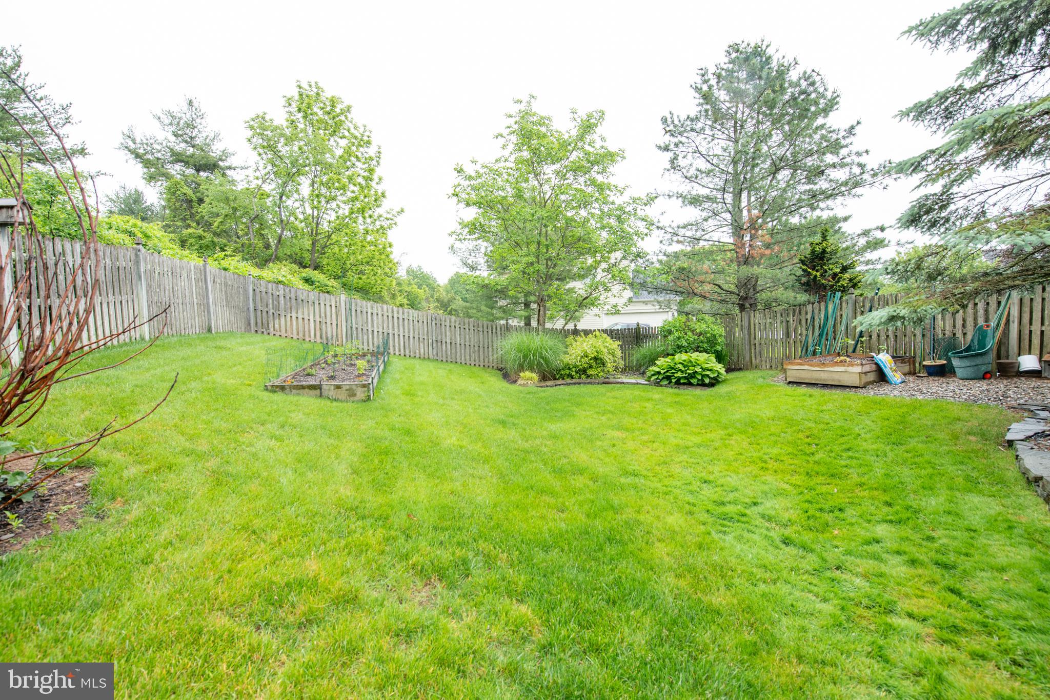 32 Eagleton Farm Road Newtown, PA 18940 - Photo 37 of 39 a view of a backyard with a slide trees and wooden fence