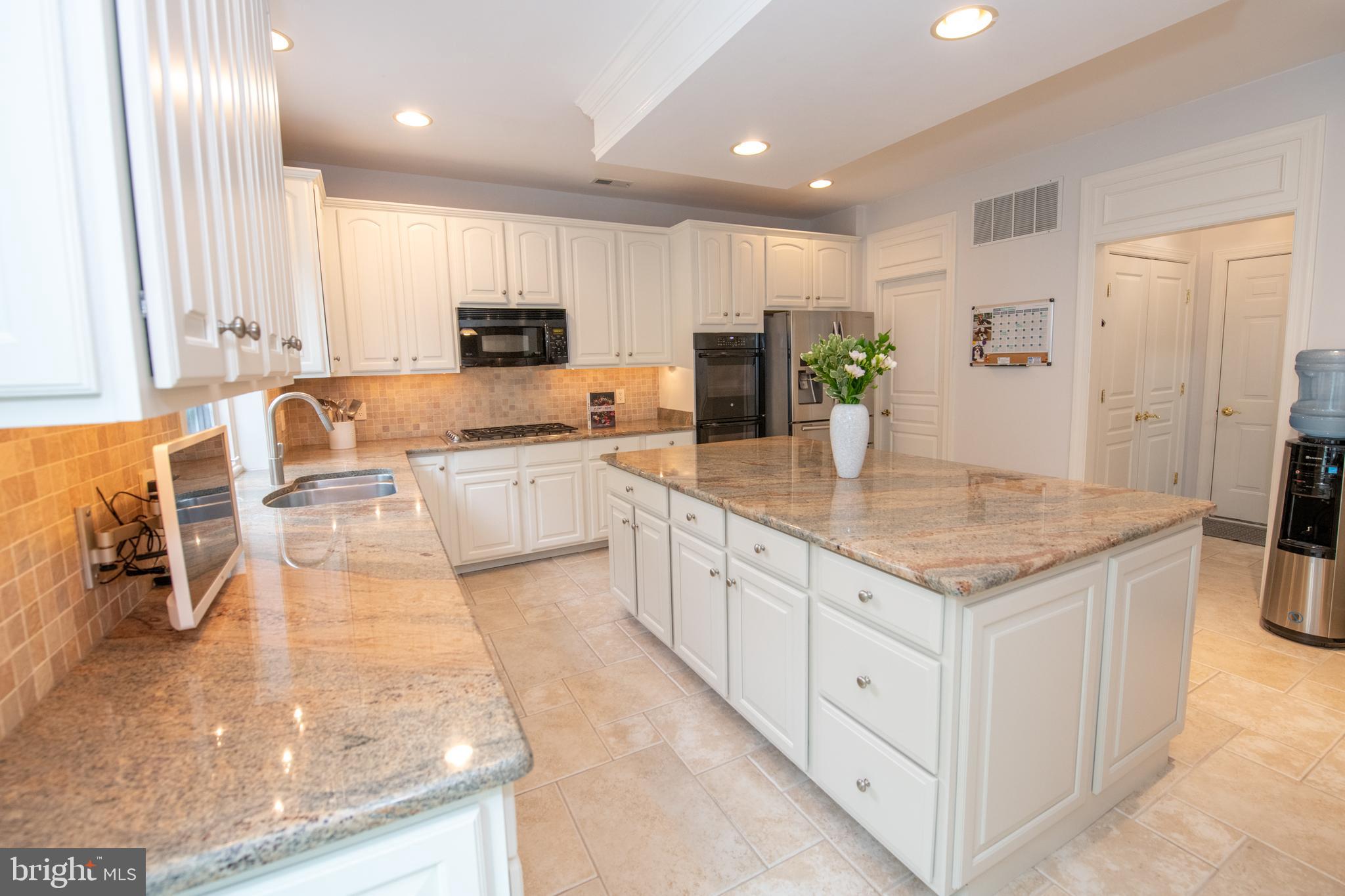 32 Eagleton Farm Road Newtown, PA 18940 - Photo 8 of 39 a large kitchen with stainless steel appliances granite countertop a large counter top a stove a sink and a refrigerator